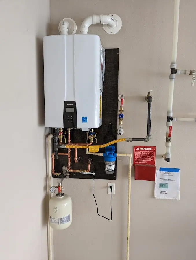 Professional plumber installing copper piping in a Killingly home